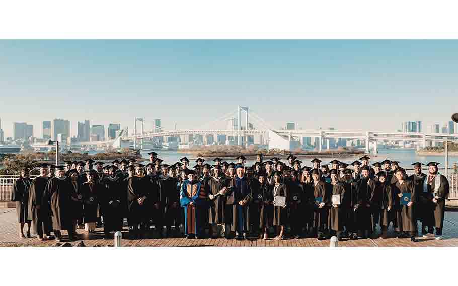 Embry-Riddle Aeronautical University Class of 2025 Graduation group photo, graduation, Odaiba’s Rainbow Bridge and the Tokyo Bay in the background
