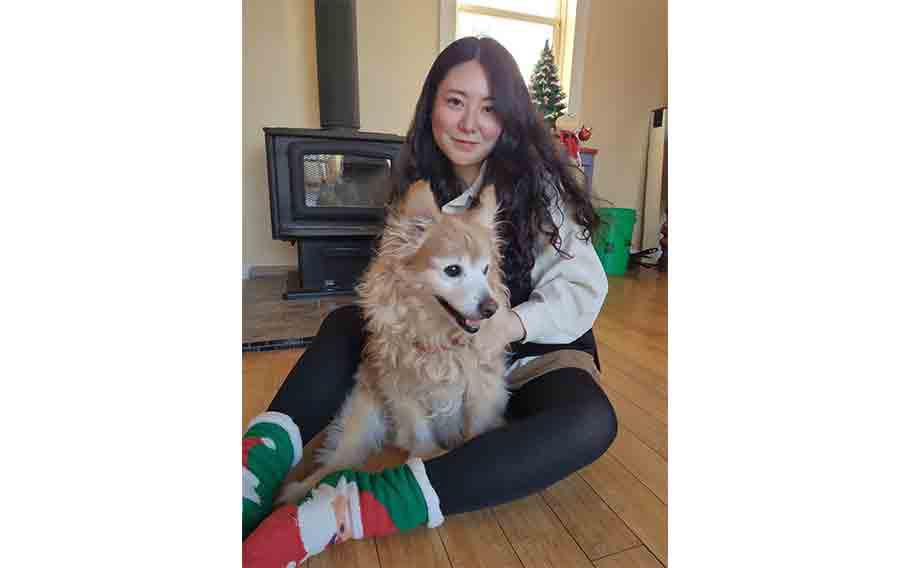 the author with a dog in an American house