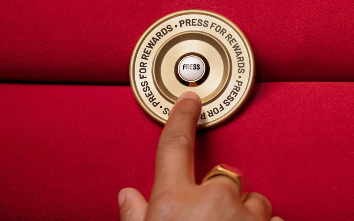 Travel Tuesday is back: your shortcut to the next adventure Image of man lingering over Press for Rewards button