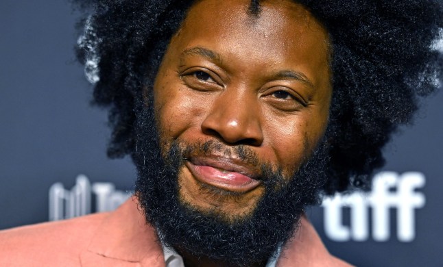 Jeremy O. Harris smiling at a premiere at the Toronto International Film Festival, wearing a pink blazer.