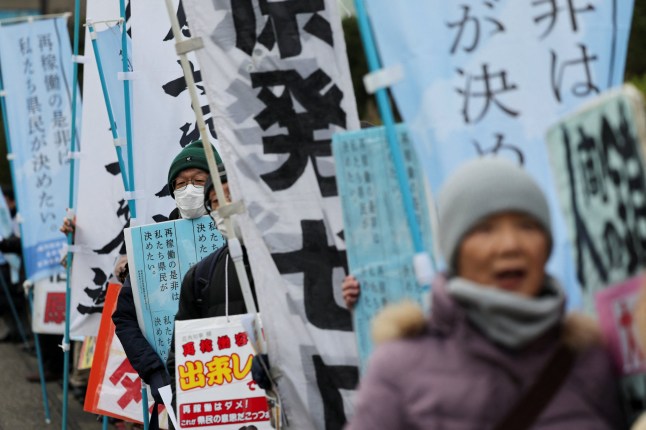 Protesters take part in a rally near Niigata prefectural government office building before voting takes place in the prefectural assembly on a partial restart of the Tokyo Electric Power Company's (TEPCO) Kashiwazaki Kariwa Nuclear Power Plant, one of the world's largest nuclear power plants and which was among the reactors shut after a massive earthquake and tsunami in 2011 crippled TEPCO's Fukushima Daiichi plant, in Niigata, Japan December 22, 2025. REUTERS/Issei Kato