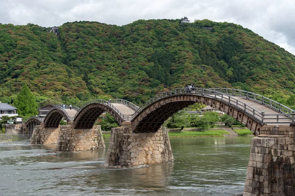 Ta-c/Adobe Stock People walking over the Kintaikyo Bridge.