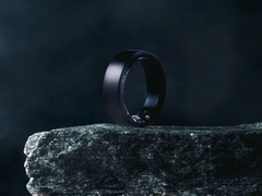 The Soxai Ring 2, pictured in a matte black finish on the edge of a rock against  a dark background. (Image source: Soxai)