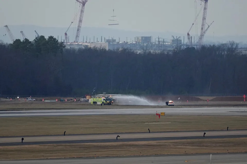 An emergency vehicle puts out a brushfire near the tarmac after United Airlines Flight 803's engine failed (REUTERS)