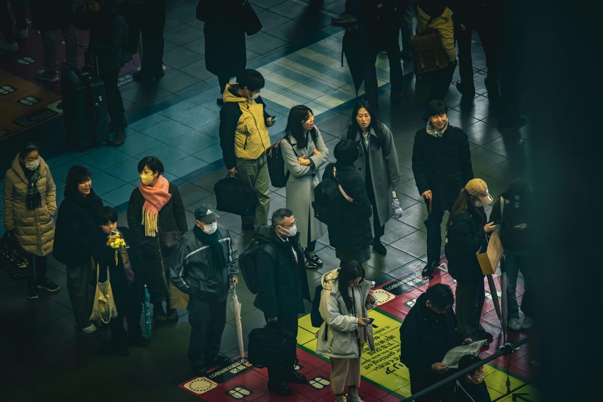 A crowd of people standing around each other in Osaka, Japan (HorseRat/Unsplash)