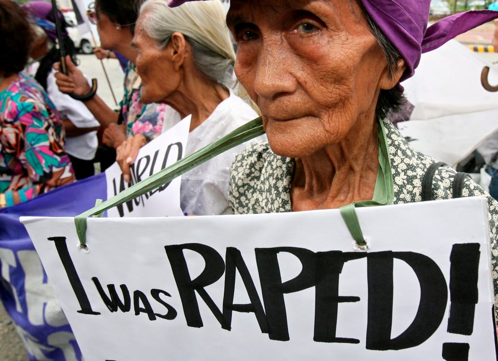 A former Filipino victim of wartime sexual slavery by Japanese troops holds a placard during a protest in 2007 outside the Japanese embassy in Manila. Photo: EPA