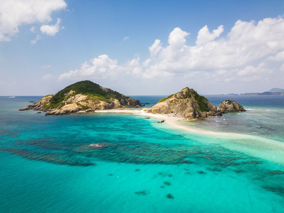 Dramatic aerial view of a stunning island off the Aharen Beach in the Tokashiki island in Okinawa in Japan
