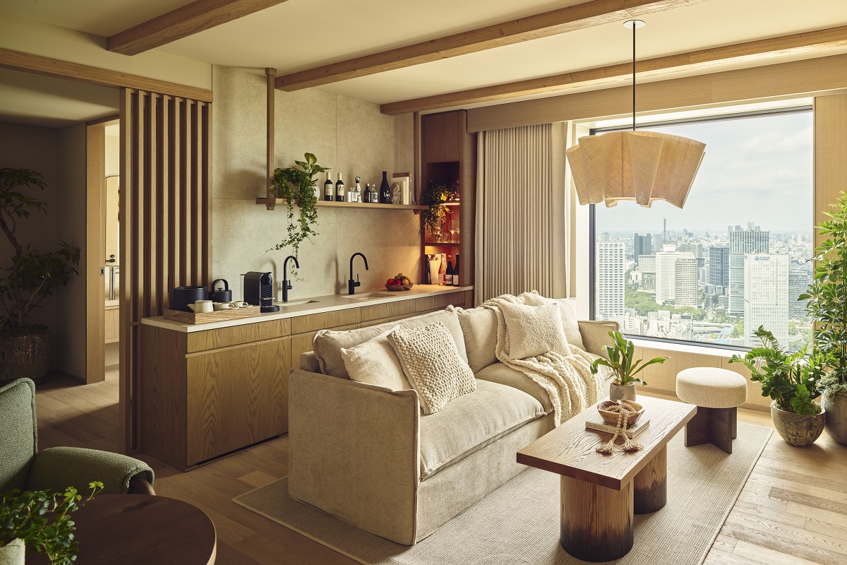 cream couch and wooden table backing onto kitchen area in 1 Hotel Tokyo_Panoramic Garden Junior Suit
