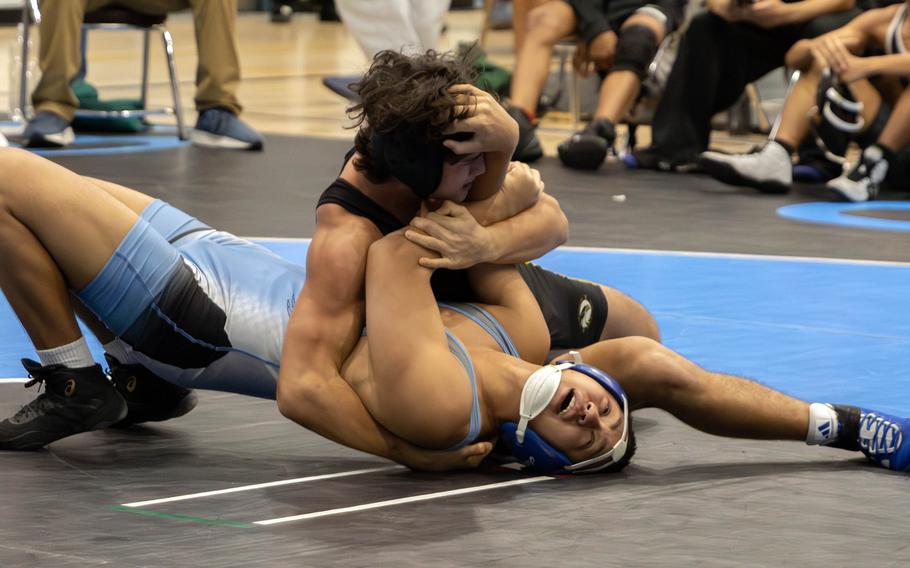 Gabriel Donatto and Logan Seen compete on the mat.