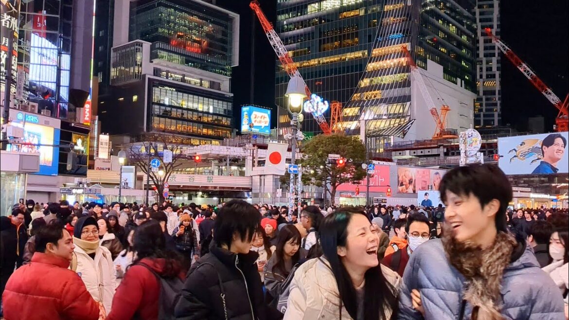 Shibuya crossing night walking tour. Tokyo, Japan.