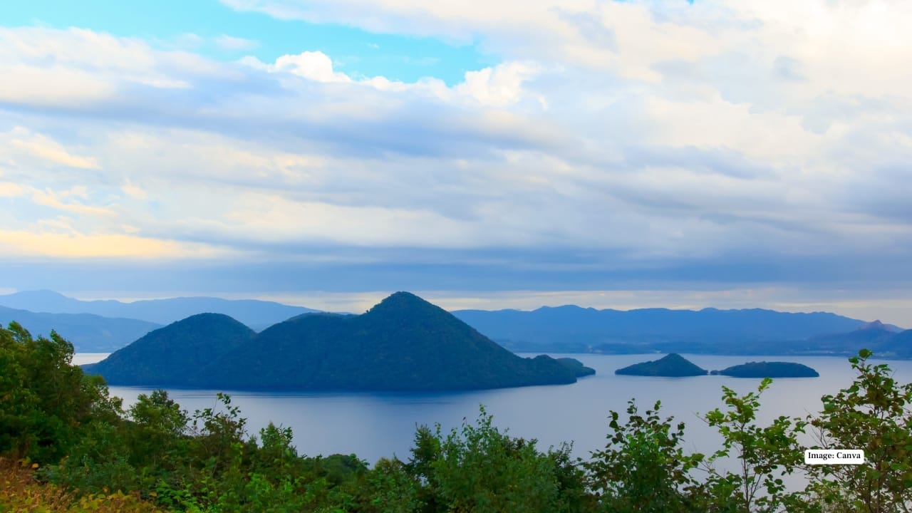 7. Lake Toya Lake Toya sits calmly within a volcanic caldera, surrounded by forested hills and distant peaks. The atmosphere here is slow and soothing—perfect for travellers looking to unwind. The nearby hot spring towns offer lakeside onsens, and during summer, fireworks light up the night sky almost daily, reflecting beautifully on the water. Stay suggestion: A lakeside ryokan for private onsen views.