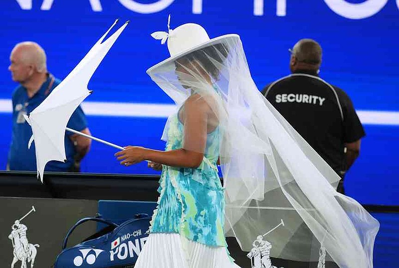 FILE - Naomi Osaka of Japan walks onto Rod Laver Arena for her first round match against Antonia Ruzic of Croatia at the Australian Open tennis championship in Melbourne, Australia, Tuesday, Jan. 20, 2026. (AP Photo/Asanka Brendon Ratnayake, File)