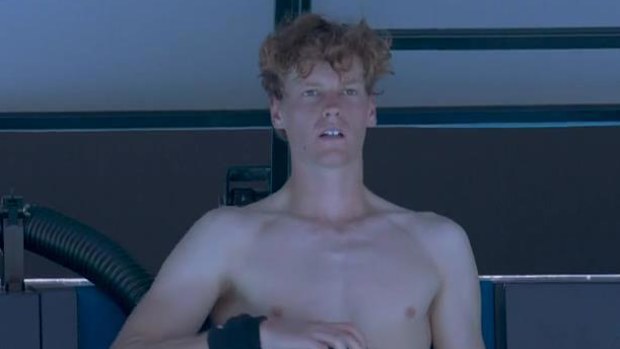 Jannik Sinner blows cold air onto himself between sets in his third round match against Eliot Spizzirri.