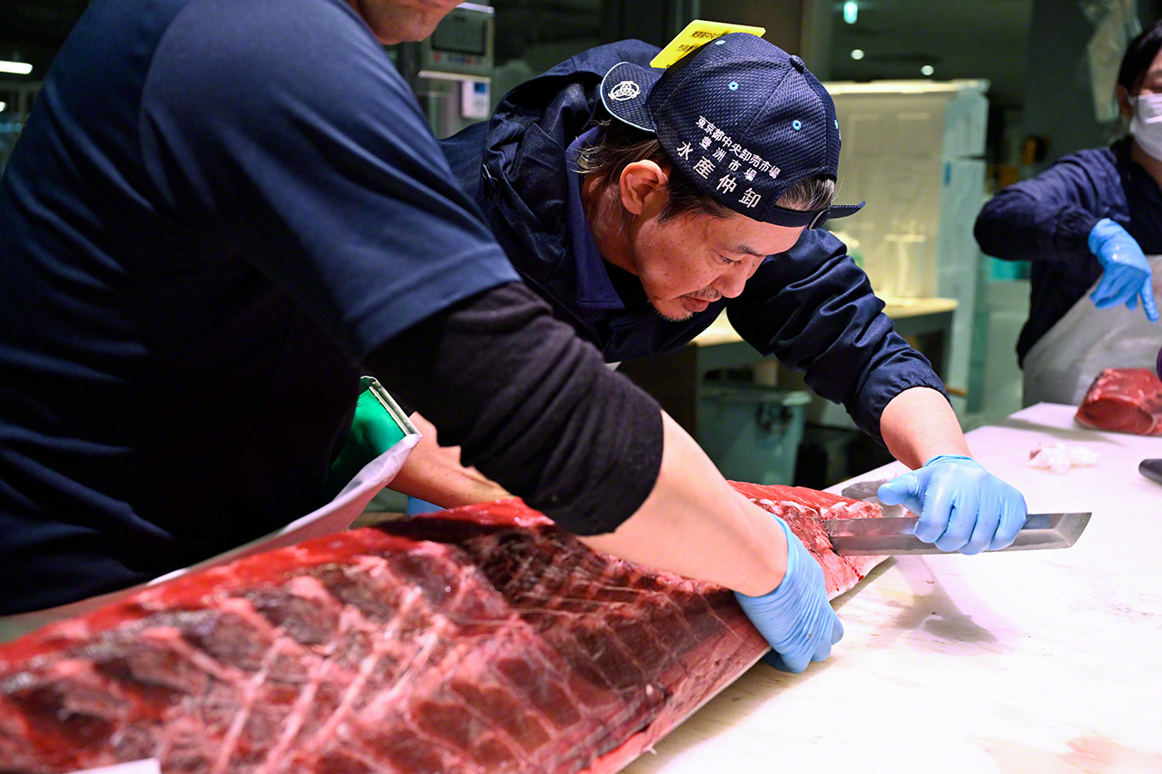 Even after it is cut in half, slicing up the fish still requires two people. (© Uzawa Akihiko)