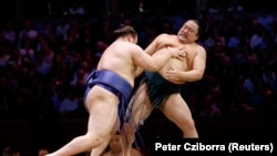 Yavhusishyn (left) takes on Japanese sumo wrestler Sadanoumi during a tournament in London in October 2025.