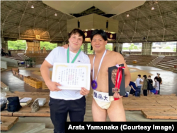 Yavhusishyn poses with Arata Yamanaka in Japan in June 2022.