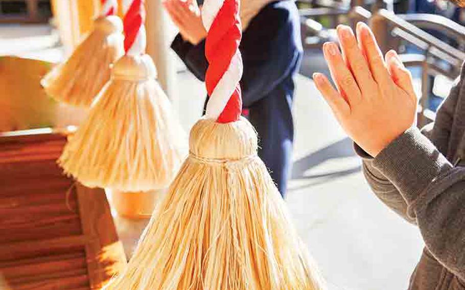 People praying at temple or shrine.