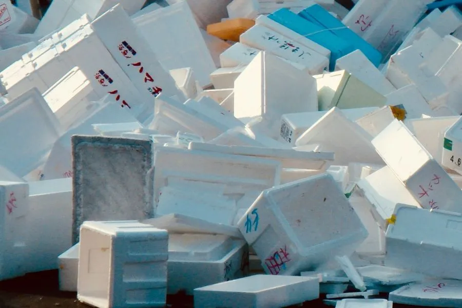 A pile of white plastic containers.