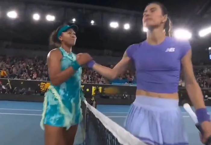 Naomi Osaka and Sorana Cirstea shake hands across a tennis net