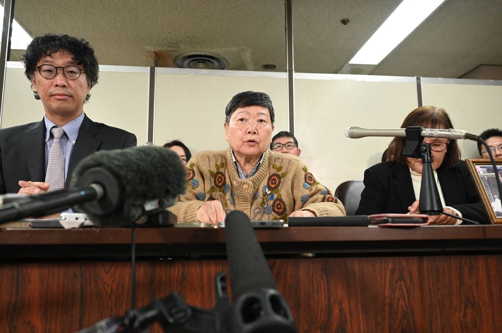 One of the plaintiffs, Eiko Kawasaki (centre), and lead lawyer Kenji Fukuda (left) speak at a press conference in Tokyo on Monday after a court ordered the North Korean government to pay compensation to former residents who moved to the North under a state-backed repatriation programme. Photo: AFP