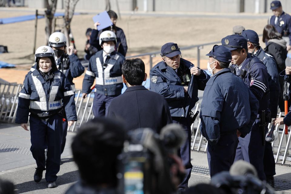 Police officers stand guard outside the Nara District Court (Koki Ohada/Kyodo News via AP)