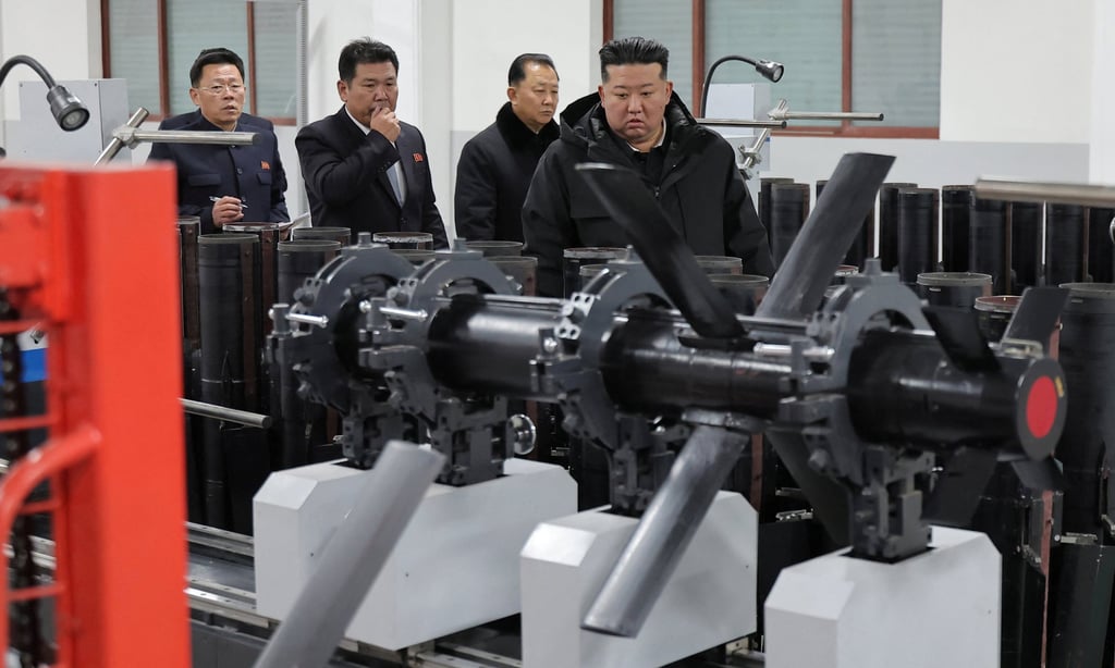 North Korean leader Kim Jong-un (right) inspects tactical guided weapons in production in a photo released on Sunday. Photo: KCNA/Reuters