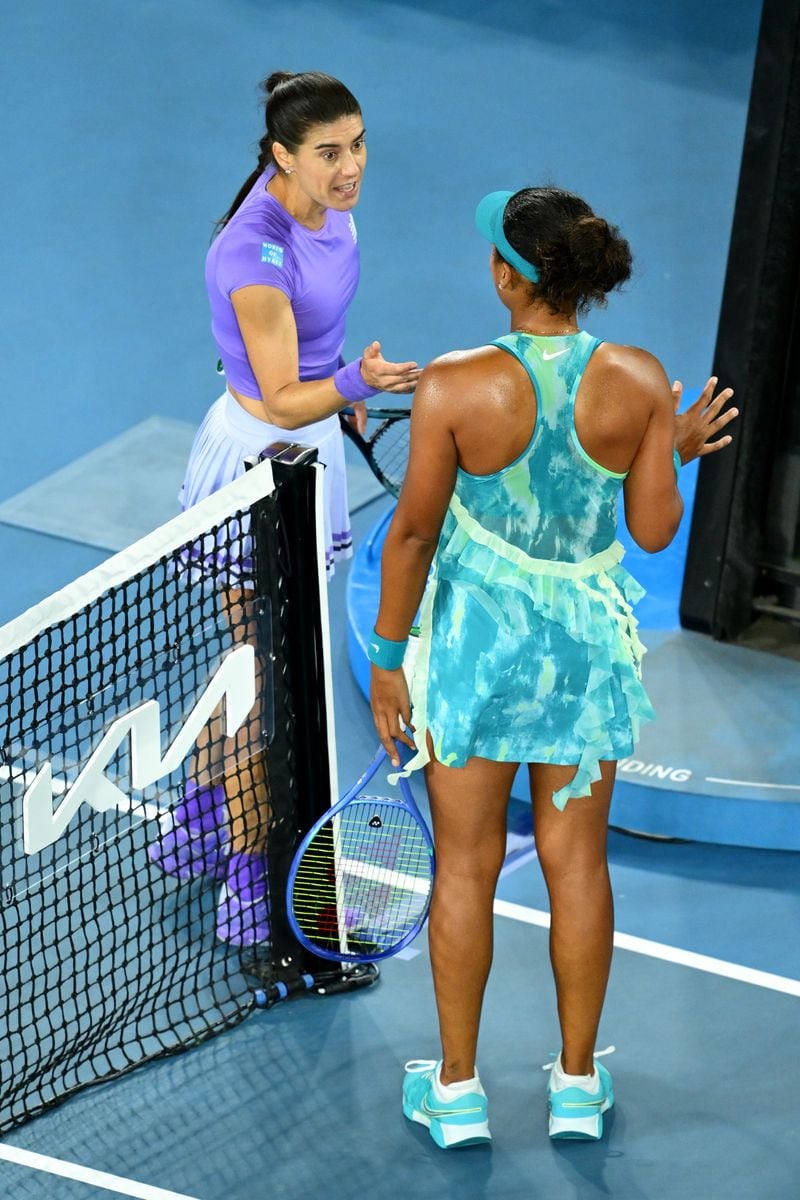 Naomi Osaka of Japan and Sorana Cirstea of Romania interact following the Women's Singles Second Round.