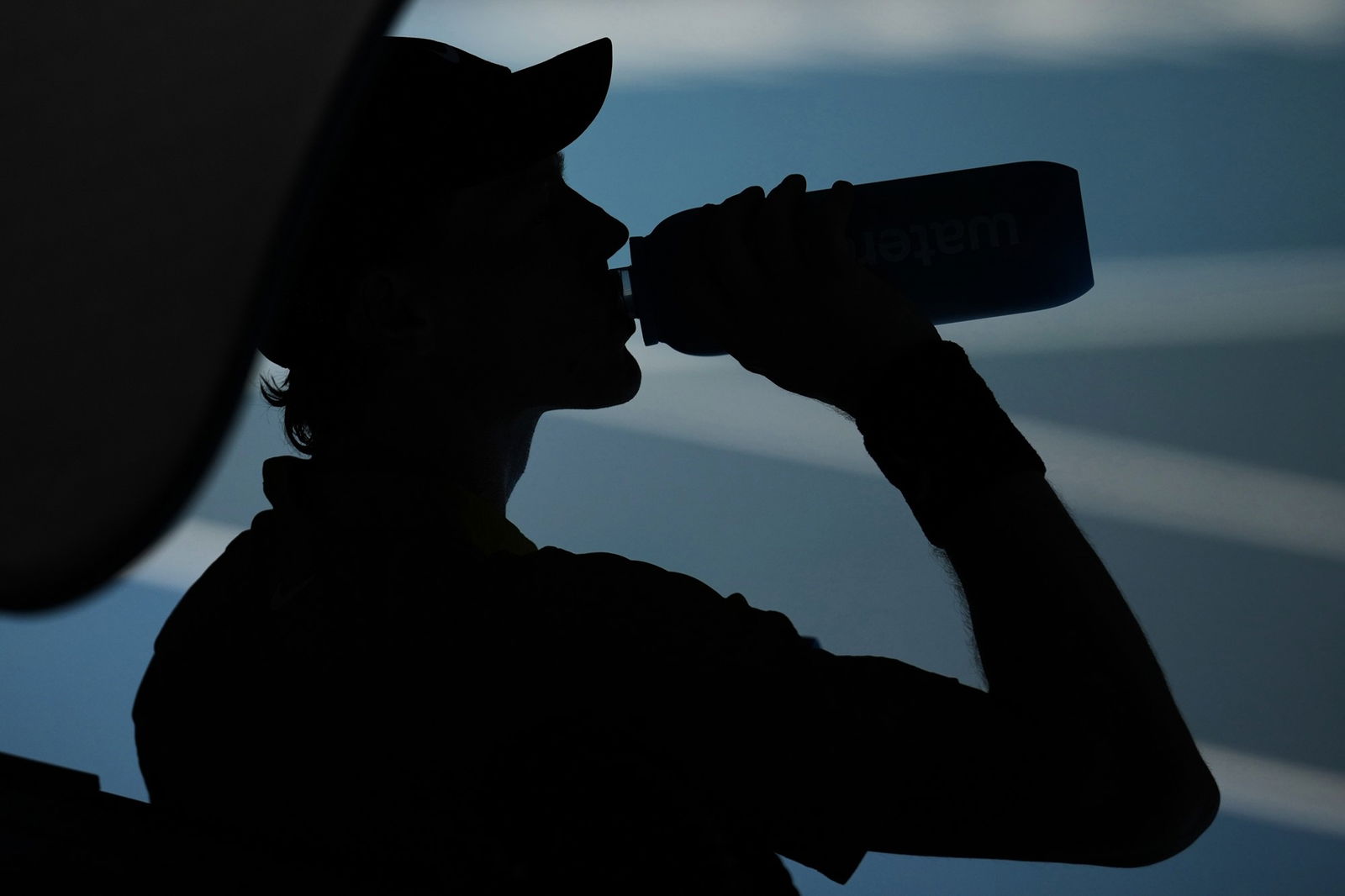 Jannik Sinner takes a drink of water.