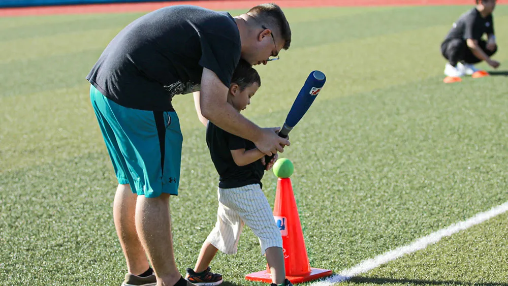 Parent and child playing tee ball [©JWL]