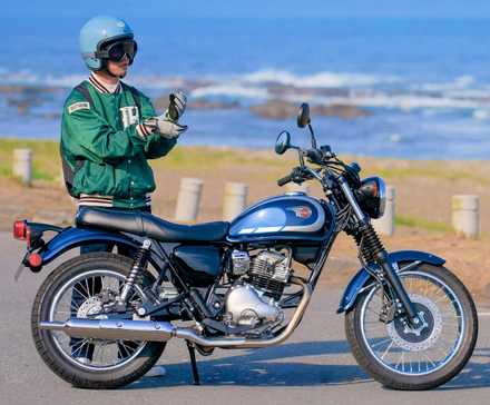 Rider standing next to a 2025 Kawasaki W230