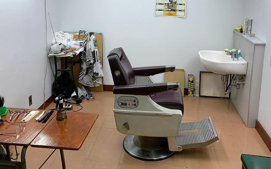 A barber’s chair in an empty shop.