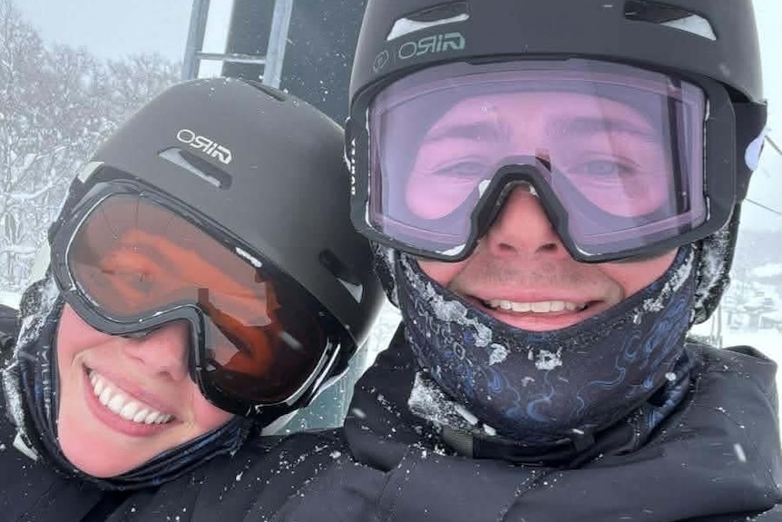 Michael Hurst (right) wearing ski googles with a person leaning on him also wearing ski googles.