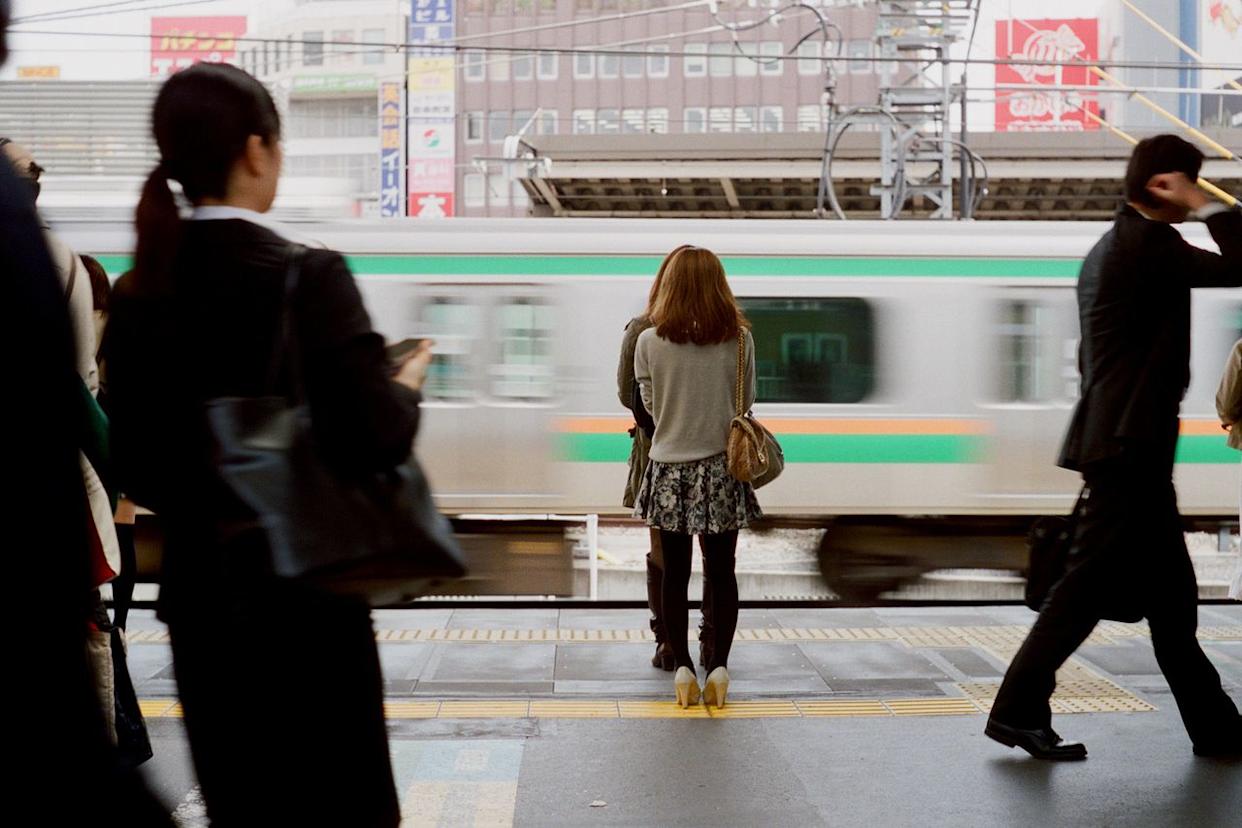 People walking on a train platform in Tokyo, Japan. PHOTOGRAPHY BY BERT.DESIGN/Getty Images