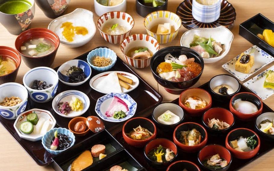 Dozens of small bowls filled with food sit on trays.