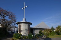 A cross mounted atop the baptistry and illuminated by the morning sun casts a shadow on the sanctuary's roof at Catholic Katsura Church in Kyoto's Nishikyo Ward, Nov. 21, 2025. (Mainichi/Takao Kitamura)