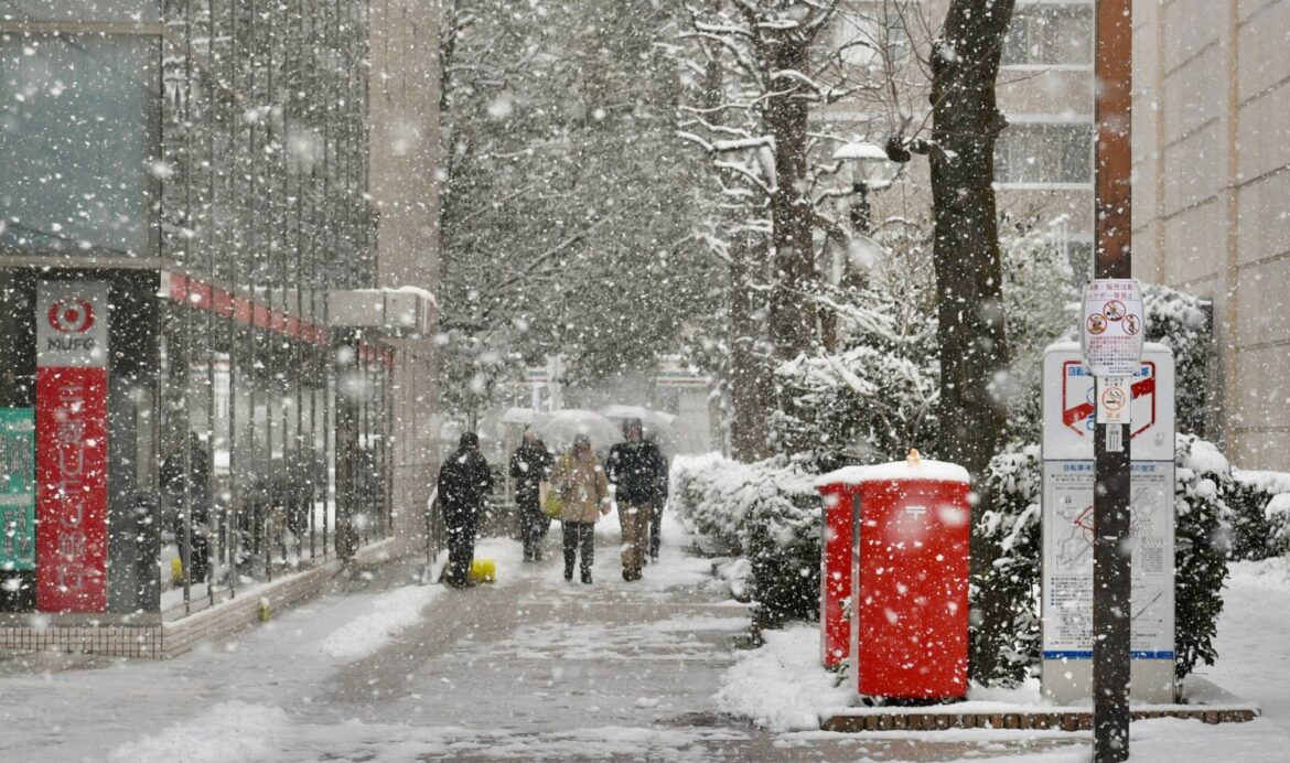 Snow blankets Tokyo as powerful storm system tightens grip on Japan