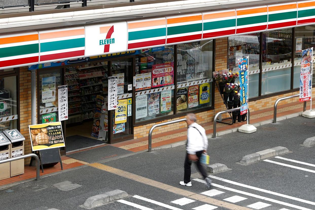 A shoper walks towards the entrance of a 7-11 in Tokyo. Kiyoshi Ota/Bloomberg via Getty Images