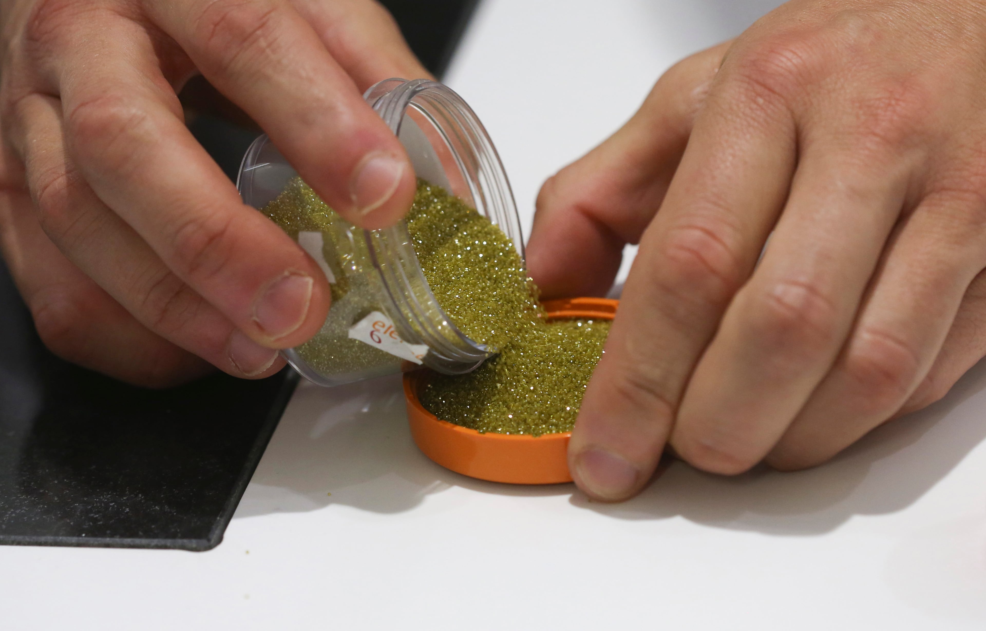 An employee pours out synthetic diamond grit at an Element Six laboratory in Didcot, U.K., on Tuesday, June 30, 2015. (Chris Ratcliffe/Bloomberg via Getty Images)