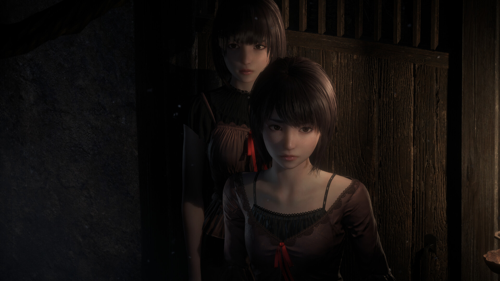 Mio and Mayu stand next to each other in shadow