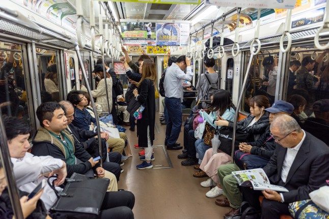 Tokyo Metro Train and Car Full of People. Going Home after Work Day