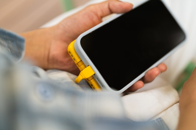 Close-up shot of a smartphone charging with a portable mobile power supply
