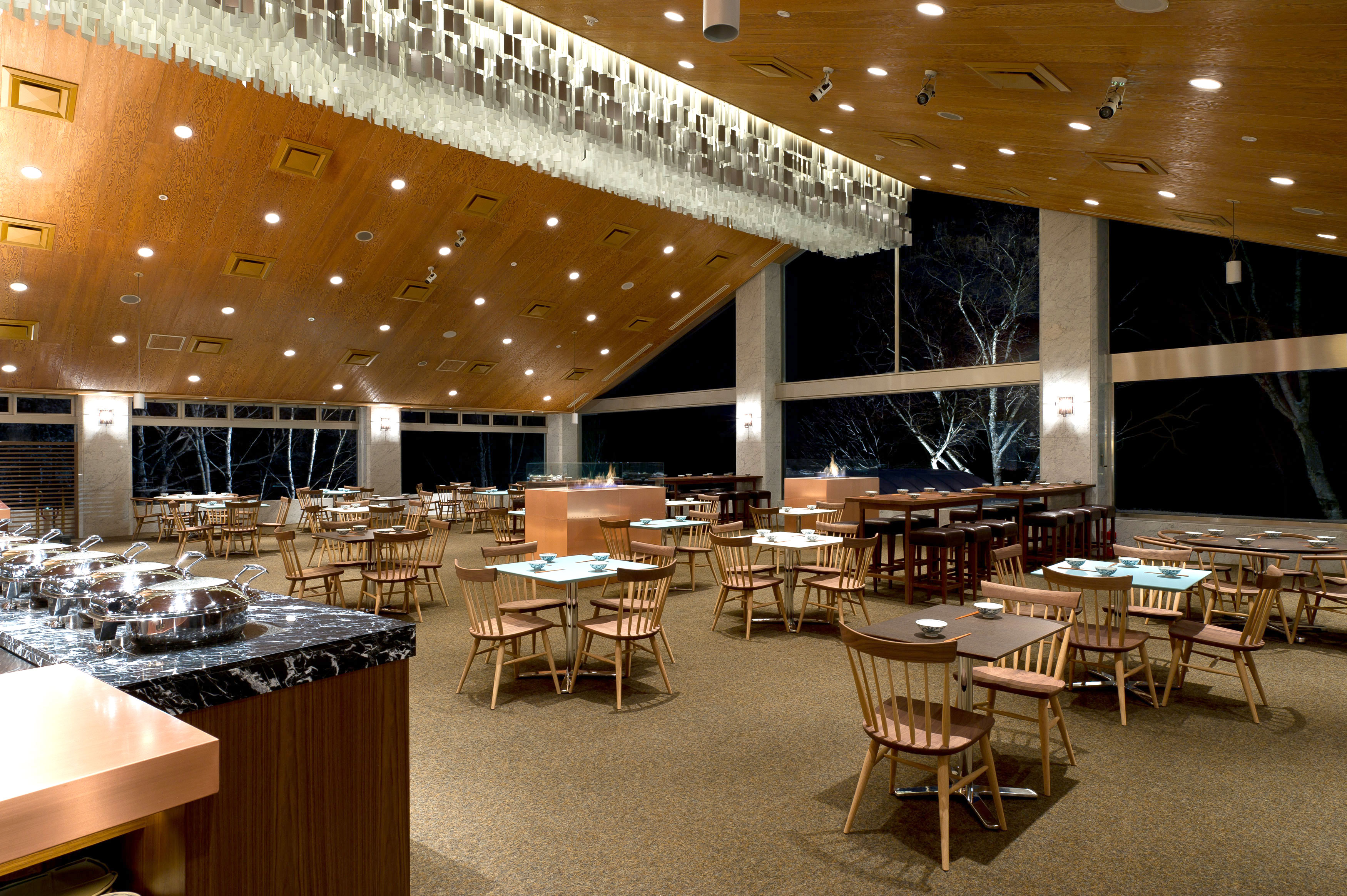 A dining room with many tables and a buffet