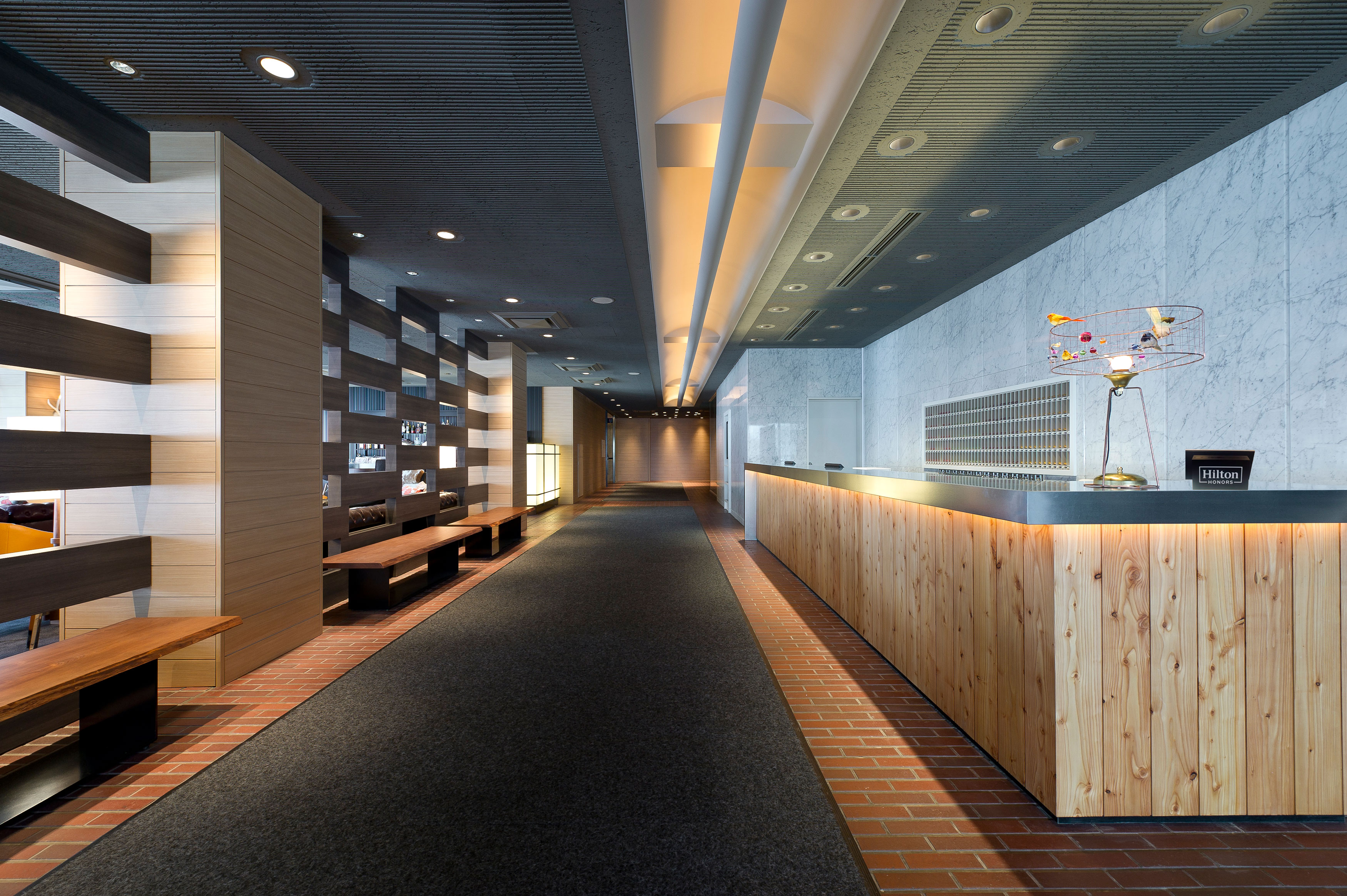 A modern lobby with large wooden front desk