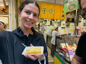 About to enjoy Tamagoyaki (an egg dish) at the Tsukiji Outer Market.