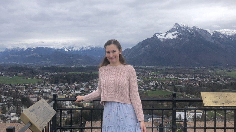 A young woman posing on a terrace at Hohensalzburg Fortress in Salzburg, Austria.