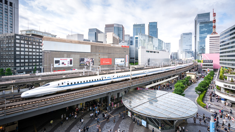A bullet train running alongside buildings in Tokyo, Japan
