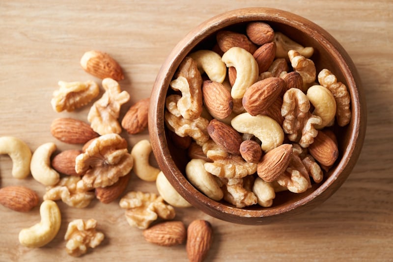 Picture of nuts in a bowl and on a table