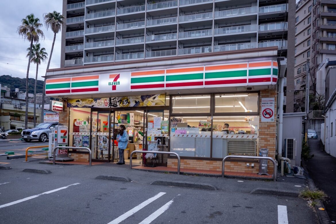 Why Combini May Become a Tourist Luxury in Japan Woman standing outside of a 7-Eleven in Atami, Shizuoka Prefecture