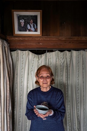 Keiko Seki holding a bowl of steaming miso udon.