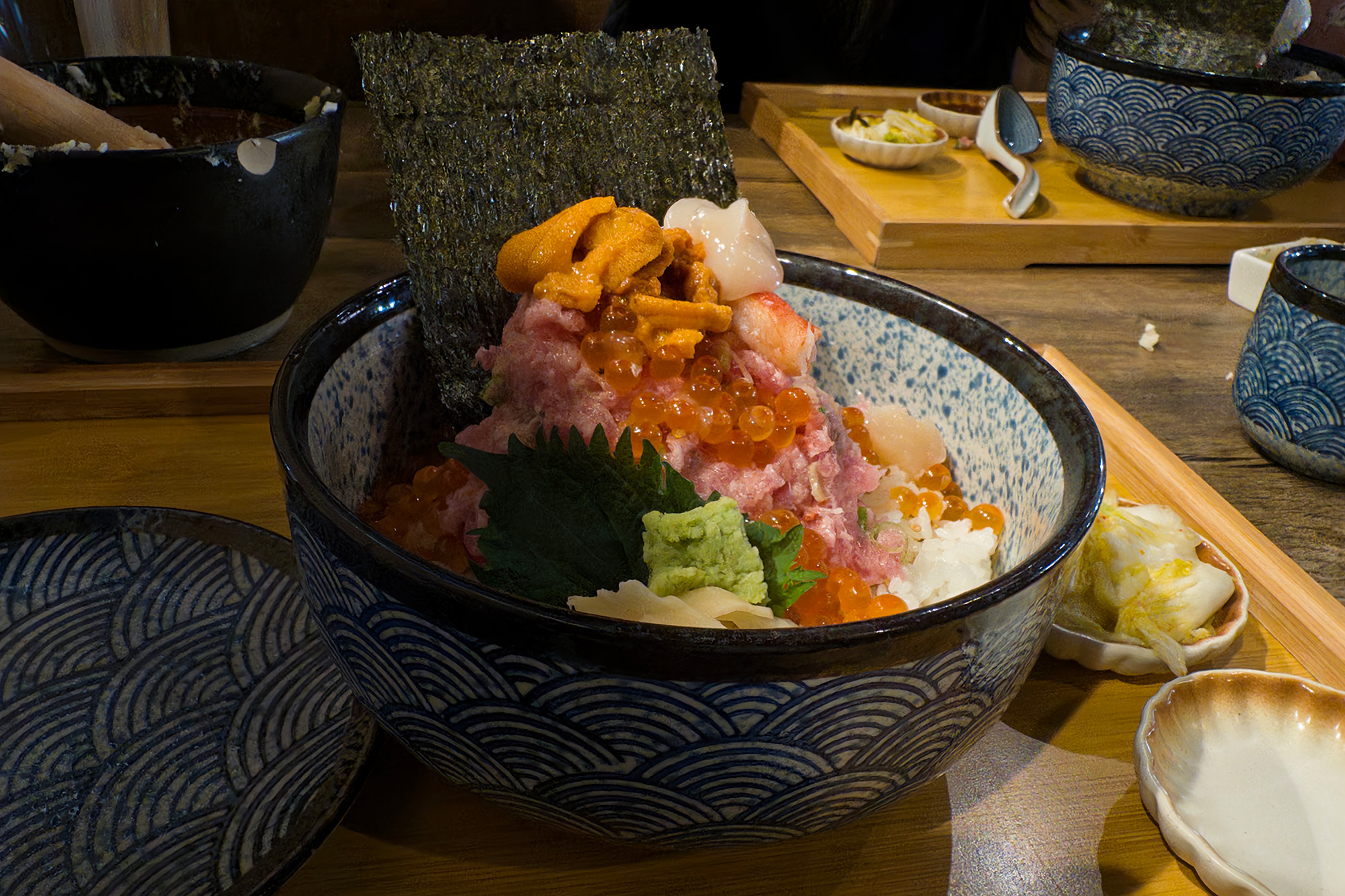 Japanese seafood bowl piled high with salmon roe, sea urchin and other assorted raw seafood.